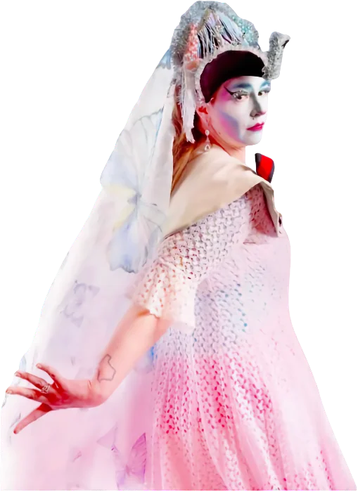 A Fourth City Sister of the Abbey of the Glittering Arch, a drag nun in whiteface makeup with an ornate silver headpiece, wearing a pink pearl-beaded gown and a sheer white veil.