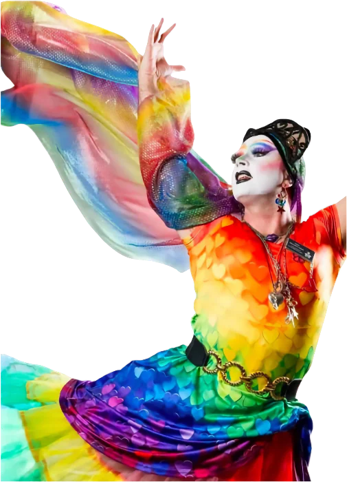 A Fourth City Sister of the Abbey of the Glittering Arch, a drag nun in whiteface makeup and a shimmering rainbow gown with flowing chiffon sleeves, arms raised in a dramatic dance pose.